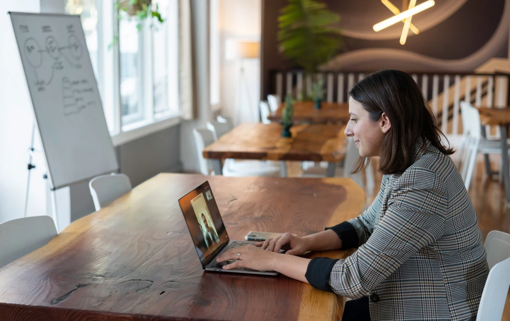 A woman using a laptop for a video call