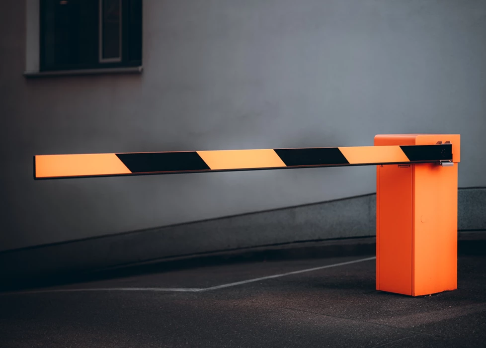 An orange parking barrier gate