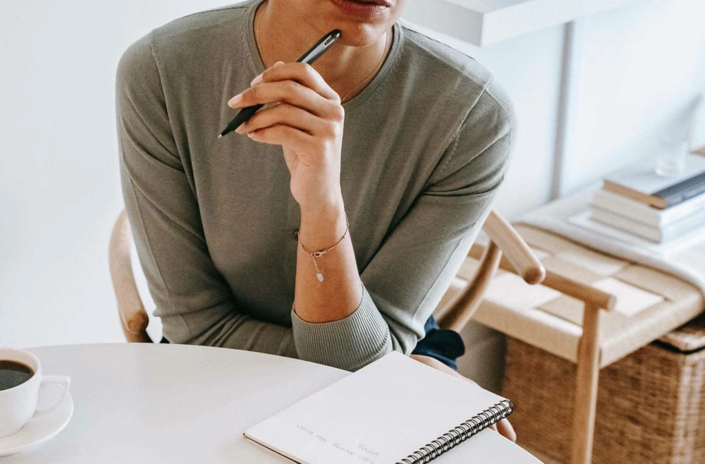 Woman writing in notepad