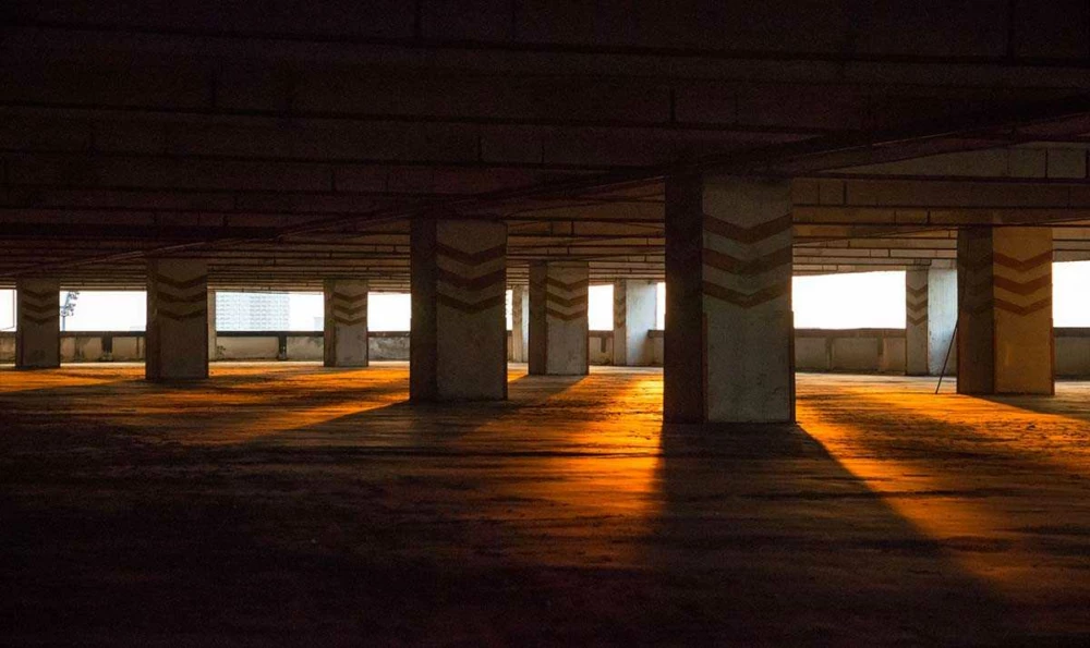 An empty parking space with concrete pillars