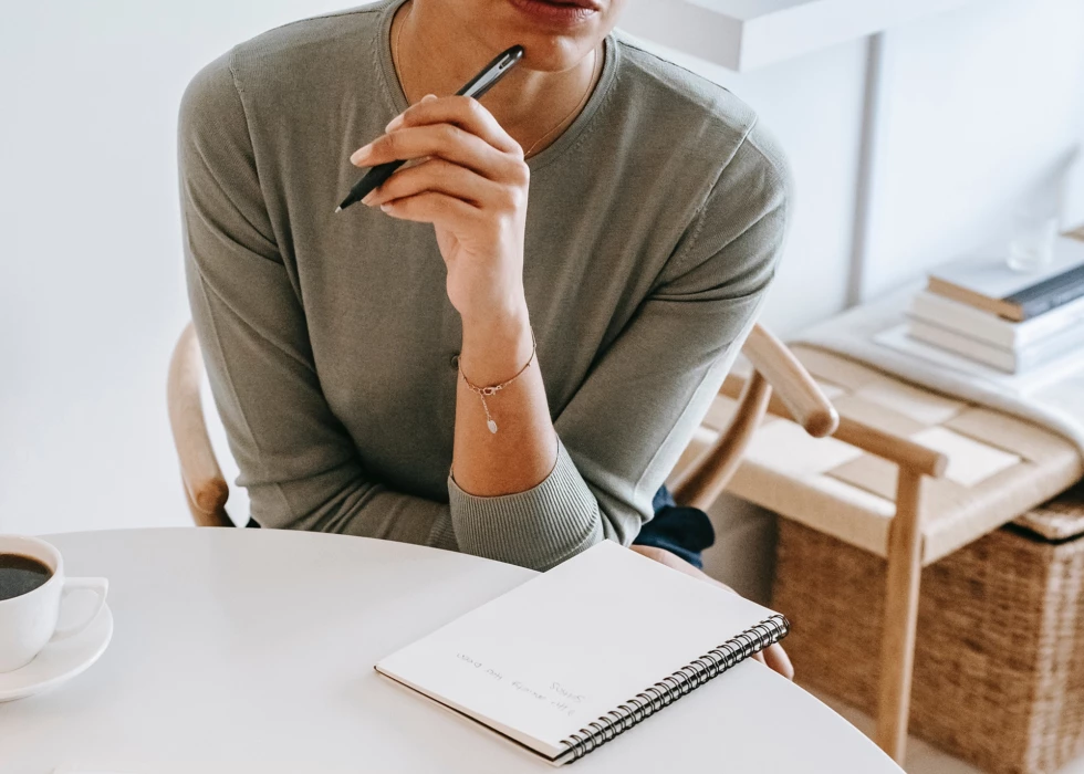 Woman thinking with notebook