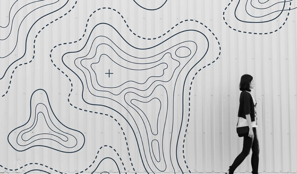 A woman walks by the white wall