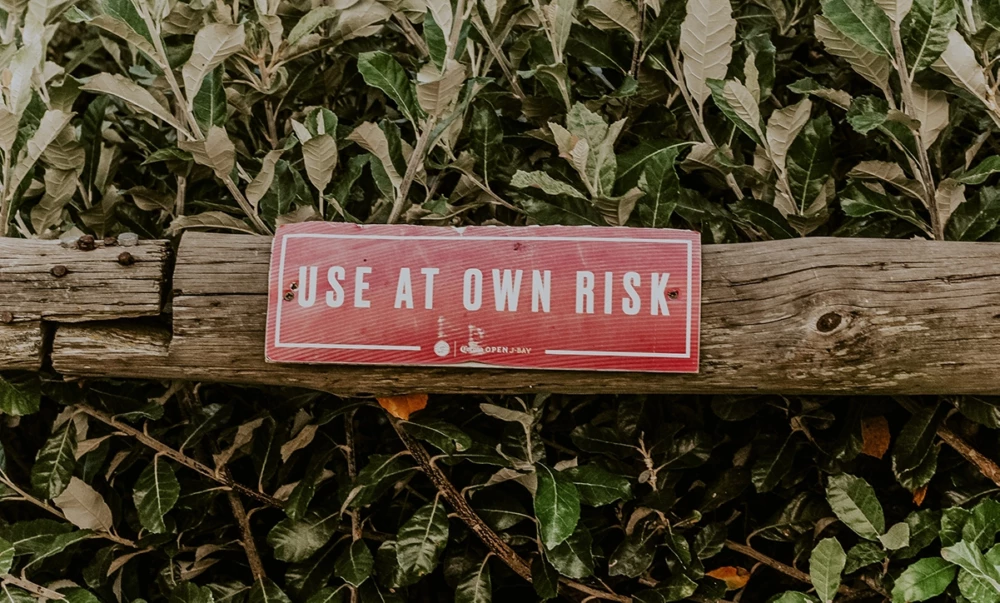 Red sign with white text "USE AT OWN RISK"