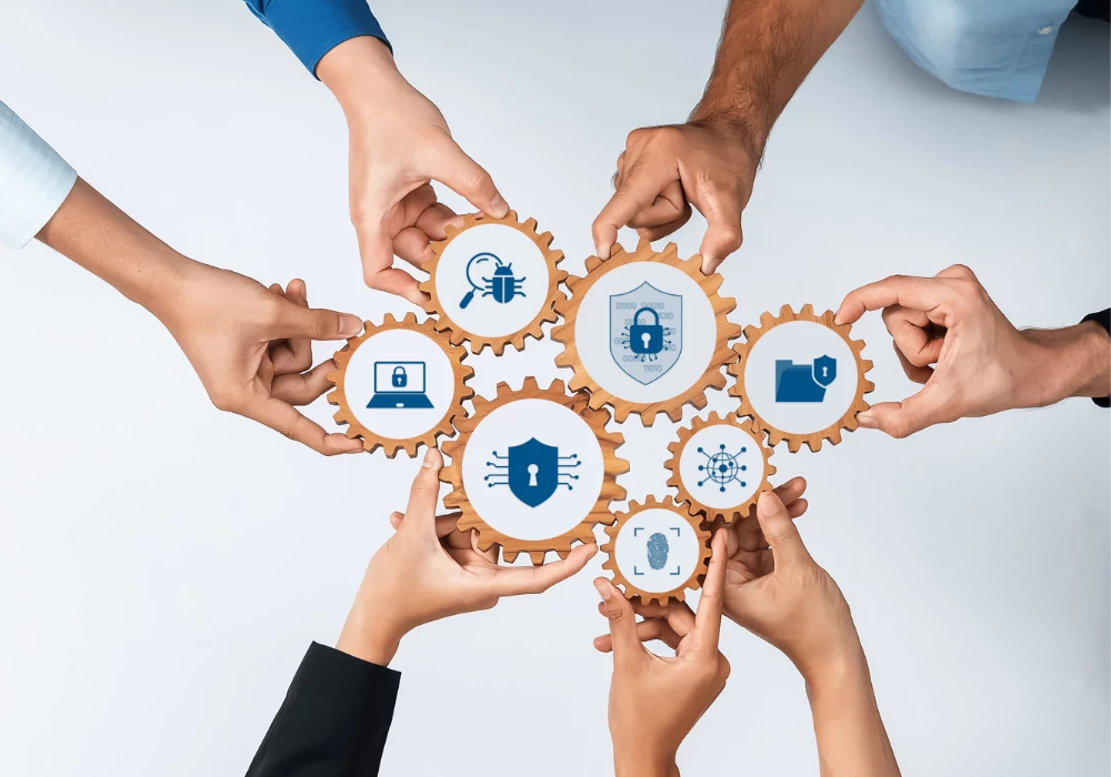 Cogs fitting together, held by team members' hands